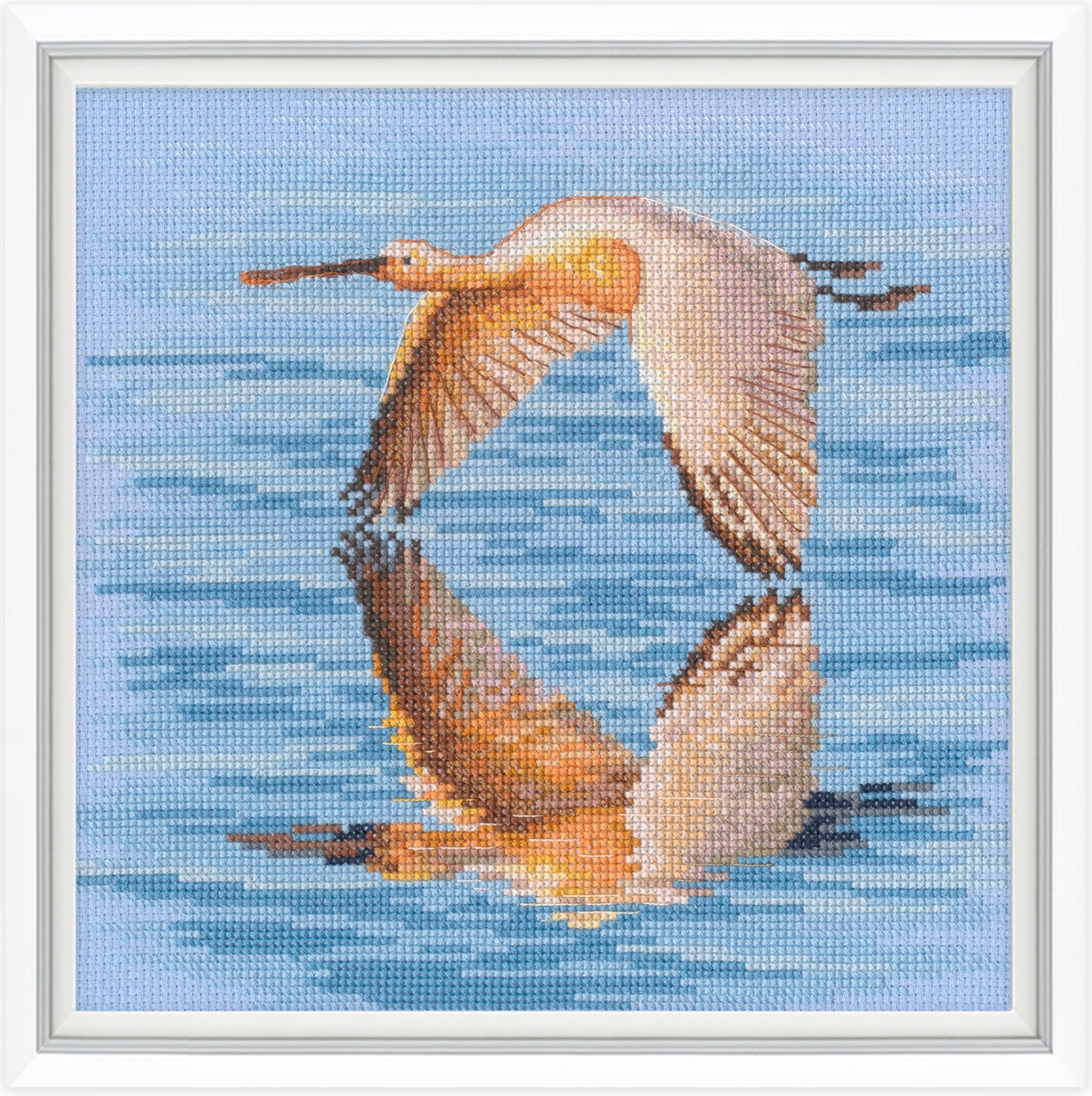 Cross-stitched design of two birds flying over water with a blue sky background.